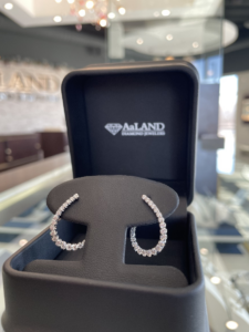 beautiful diamond earrings stored in an AaLand Diamond Jewelers jewelry box